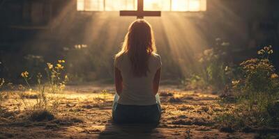 Woman meditates in a sunlit space with a cross, surrounded by flowers and a tranquil atmosphere photo