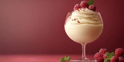 Creamy dessert with whipped cream and fresh raspberries served in an elegant glass bowl photo