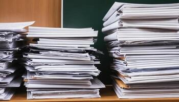 Stacked Papers On Wooden Surface With Green Background photo