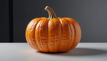 a pumpkin is sitting on a table in front of a gray wall photo