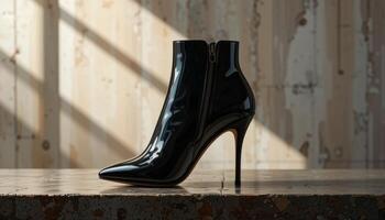 Black Patent Leather Stiletto Ankle Boots on Rustic Surface photo