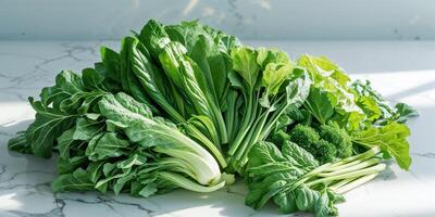 Fresh Green Leafy Vegetables Arranged On Marble photo