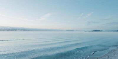 Serene Ocean Background with Calm Blue Waters and Soft Fog in the Distance. photo