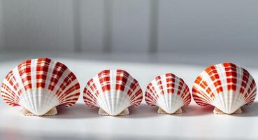 Five red and white shells are lined up on a table photo