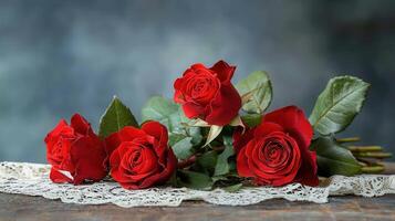 Romantic Red Roses Bouquet on Rustic Wooden Table with Lace photo