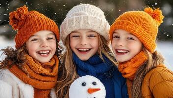 Three Happy Girls in Winter Hats and Scarves Playing in the Snow with a Snowman photo