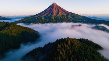 Majestic Volcanic Peak Rising Above Misty Evergreen Forest Landscape photo
