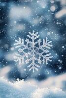 Close-up of a sparkling snowflake against a blurred winter background with falling snowflakes and icy blue tones photo
