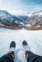 Skiing down a snowy mountain slope with alpine landscape in the background photo