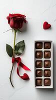 Red rose with chocolates and heart shapes for valentine's day or romantic occasion photo