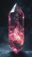 Large pink crystal with unique patterns and textures on dark background photo