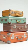 Colorful vintage suitcases stacked on each other in a stylish arrangement photo
