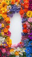 Colorful floral frame with various flowers surrounding empty space for text photo