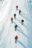 Group of skiers on a snowy slope photo