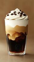 Iced coffee with whipped cream and coffee beans in a glass cup photo