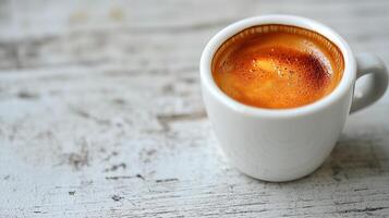 Close-up of a fresh espresso coffee in a white cup on wooden table photo