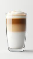 Layered latte in a clear glass on a light background photo