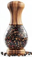 Beautiful wooden pepper mill filled with colorful peppercorns against a clean background photo