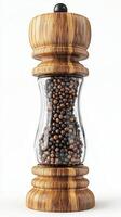 Elegant wooden pepper grinder with glass container filled with black peppercorns photo
