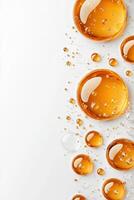 Close-up of amber-colored water droplets on a white background photo