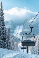 Snowy ski resort chairlift under blue sky with cloudy mountains in background photo