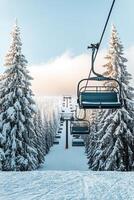 Winter mountain ski resort chairlift surrounded by snowy pine trees photo