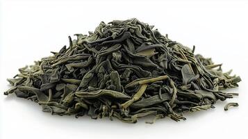 Dried green tea leaves pile on white background photo