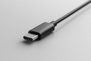 Close-up of a black usb type-c cable connector on a gray background photo