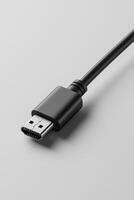 Close-up of a black usb connector on a grey background, showcasing high-quality tech details photo