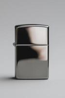 Sleek silver zippo lighter on grey background photo