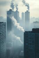 Industrial skyline during foggy weather with smoke rising from buildings photo