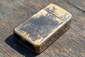 Vintage zippo lighter with distressed finish on weathered wooden surface photo