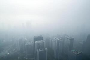 Foggy cityscape with skyscrapers and urban skyline in low visibility photo