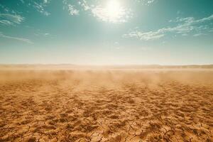 Vast arid desert landscape under a bright sun with cracked ground and dust clouds photo