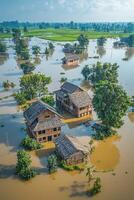 Aerial view of flooded rural houses surrounded by water and lush greenery photo