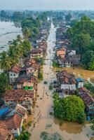 Aerial view of flooded village streets surrounded by lush greenery and homes in a rural setting photo