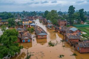 Aerial view of flooded rural village with submerged houses and surrounding greenery photo