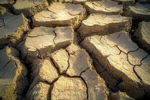 Cracked dry earth surface showing drought and desertification patterns photo
