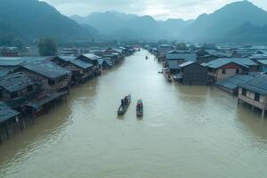 Flooded village with boats on a river amidst misty mountains at dawn photo