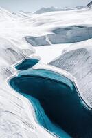 Stunning aerial view of ice-covered mountains with glacial blue lakes in a frozen landscape photo