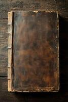 Antique leather bound book on dark wooden table photo