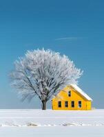 A yellow house stands alone in a snowy field under a clear sky photo