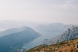 View from the mountain of the valley of the Bay of Kotor surrounded by a mountain range in a light haze. Montenegro photo