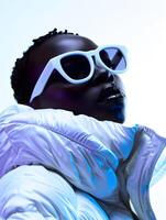 A man in sunglasses and a white jacket gazes upward photo