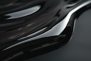 A fluid stream of glossy black material flowing gracefully across a smooth surface. photo