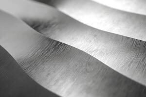 Close-up of elegant silver waves showcasing brushed metal texture and light reflection. photo