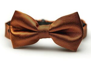 An elegant orange bow tie laid flat on a white background, showcasing its intricate texture and silk-like sheen. photo