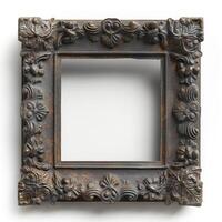 An ornate, vintage square mirror with intricate floral carvings in a distressed dark finish. photo