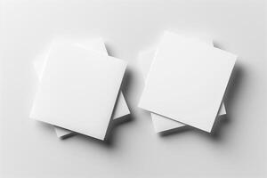 A minimalist arrangement of four blank white sticky notes with a smooth surface, creating a clean and organized aesthetic. photo