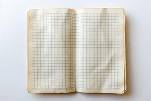 An open vintage graph notebook with a plain blue grid pattern, showcasing its empty pages and weathered edges. photo